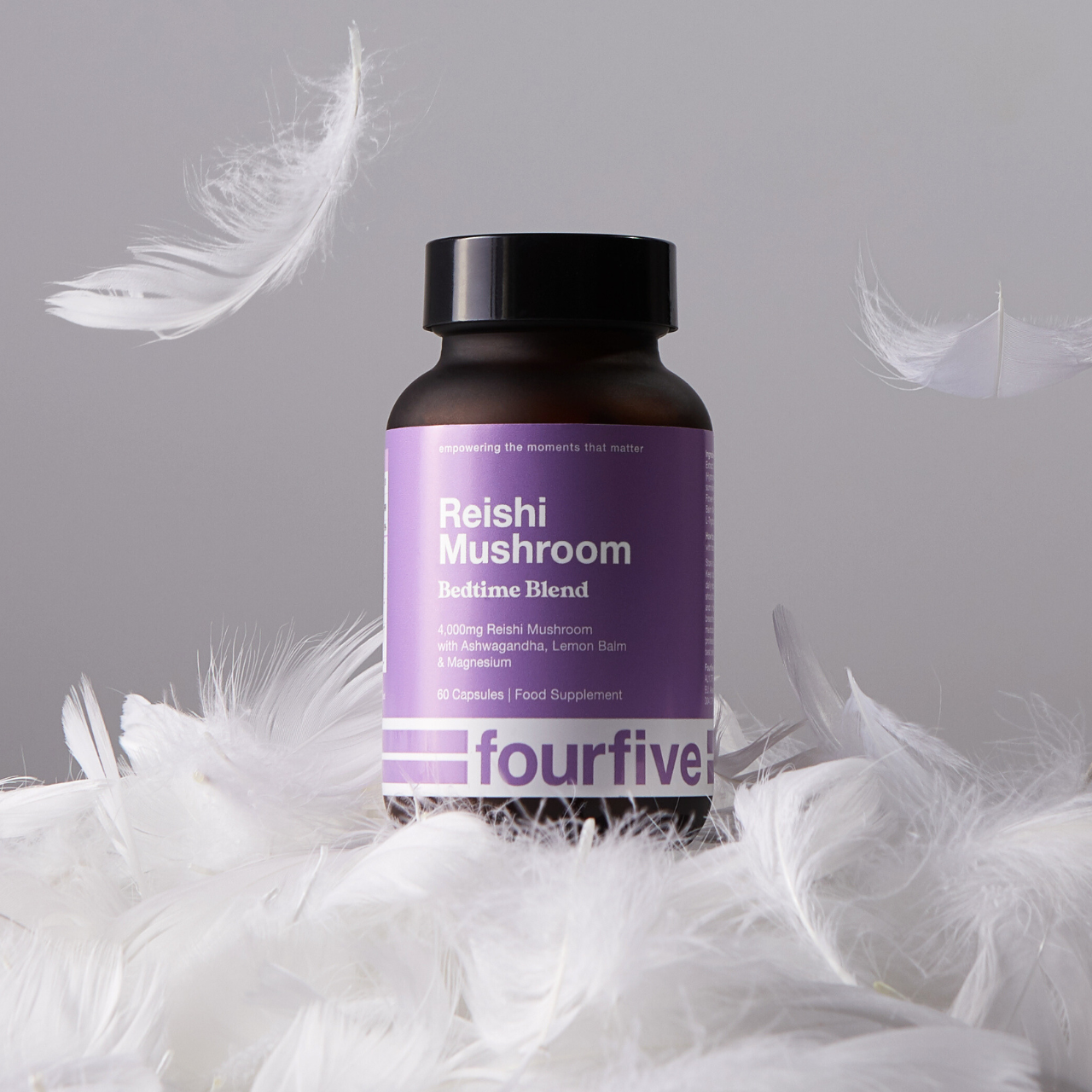 Bottle of Reishi Mushroom Bedtime Blend on a bed of feathers