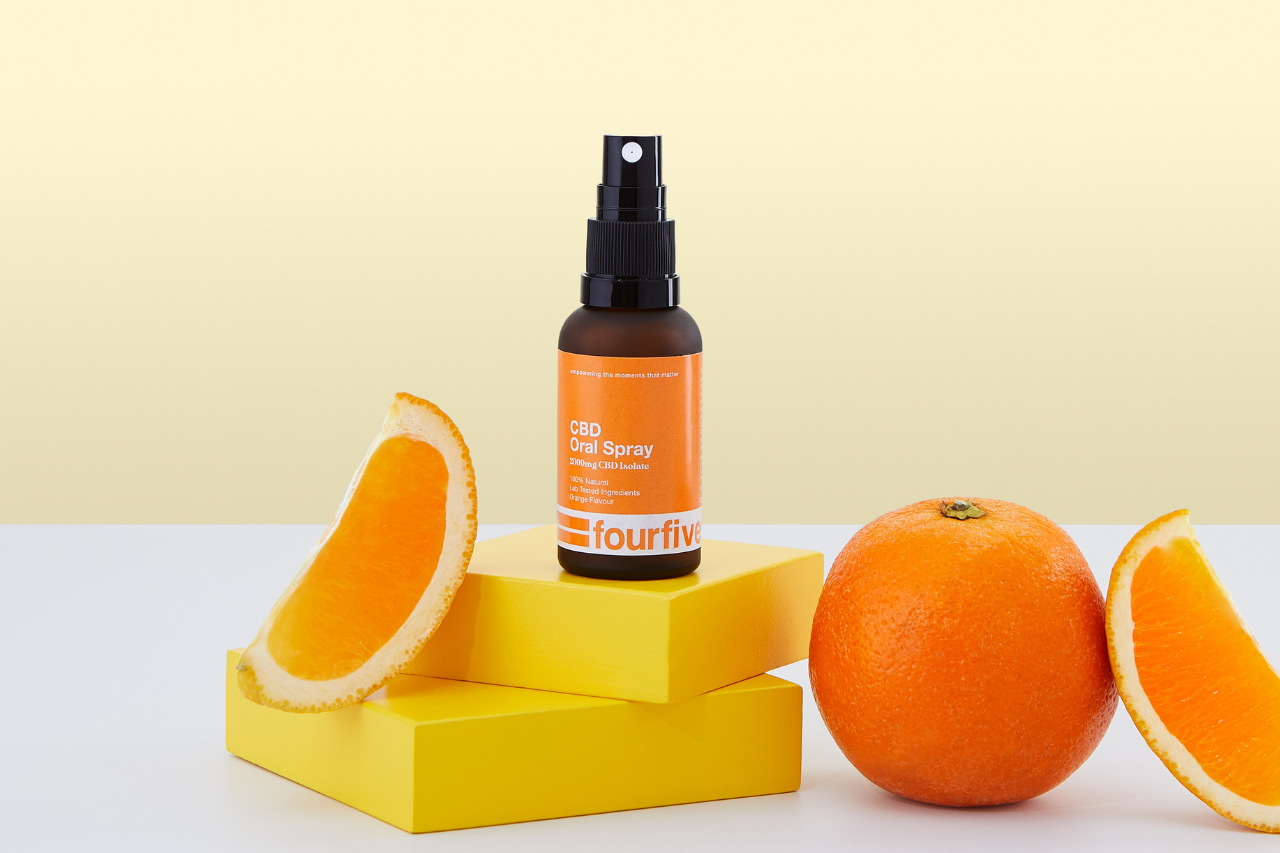 Orange flavour CBD Oil Spray bottle with oranges surrounding