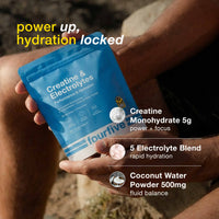 Person holding a fourfive Creatine & Electrolytes supplement package with text highlighting key ingredients.