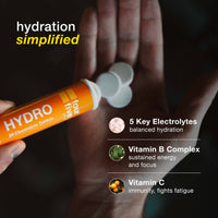 Hand holding a tube of 'four five' Hydro electrolyte tablets with text highlighting benefits on a dark background.
