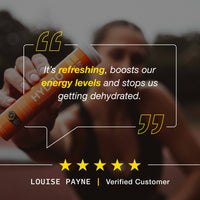 Person holding a energy drink with a customer review quote on a dark background